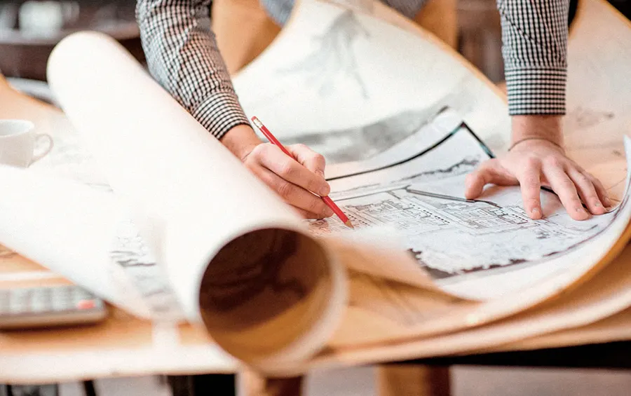 Architect drawing on building plans