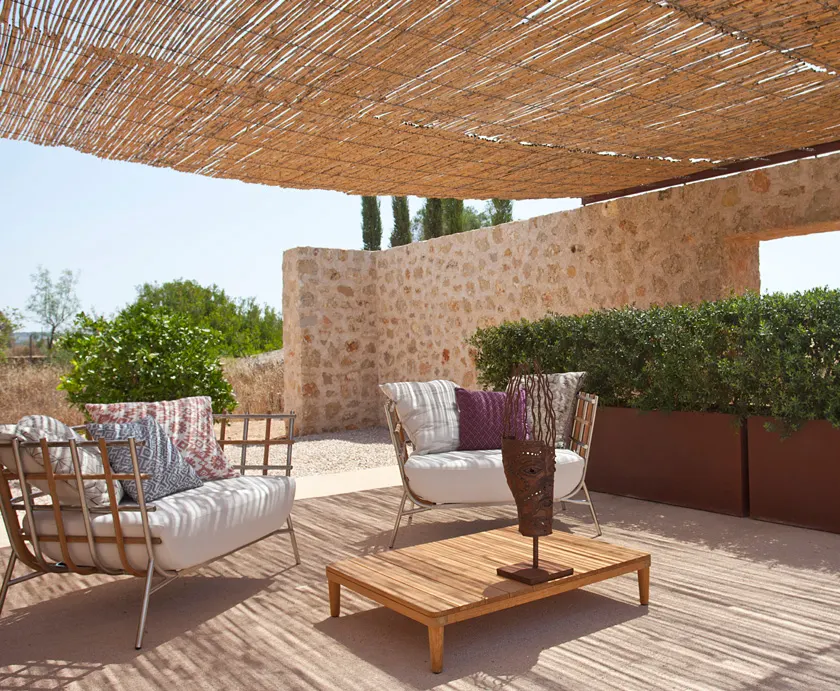 Shaded terrace with a natural stone wall